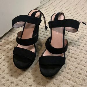 Black strapped wedge heals